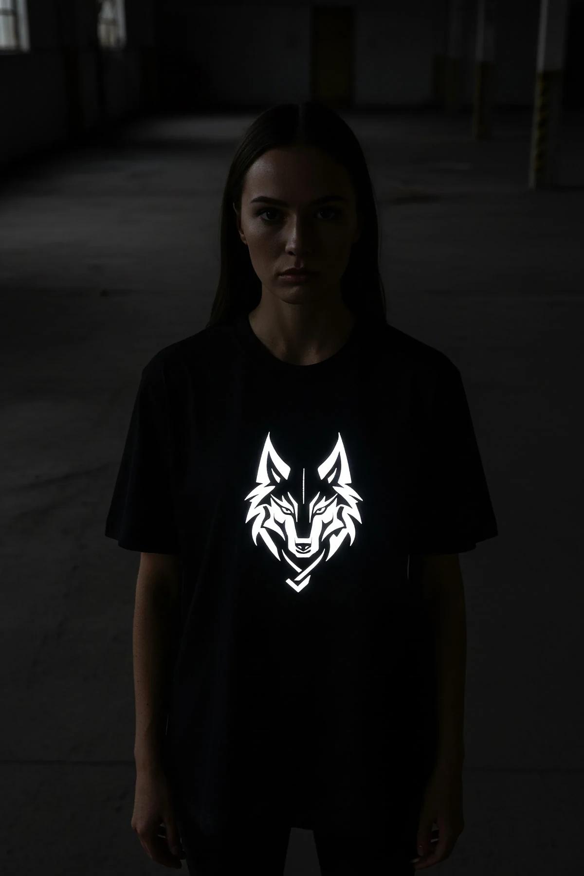 black oversize wolf tee daylight view showing white matte geometric wolf graphic on chest