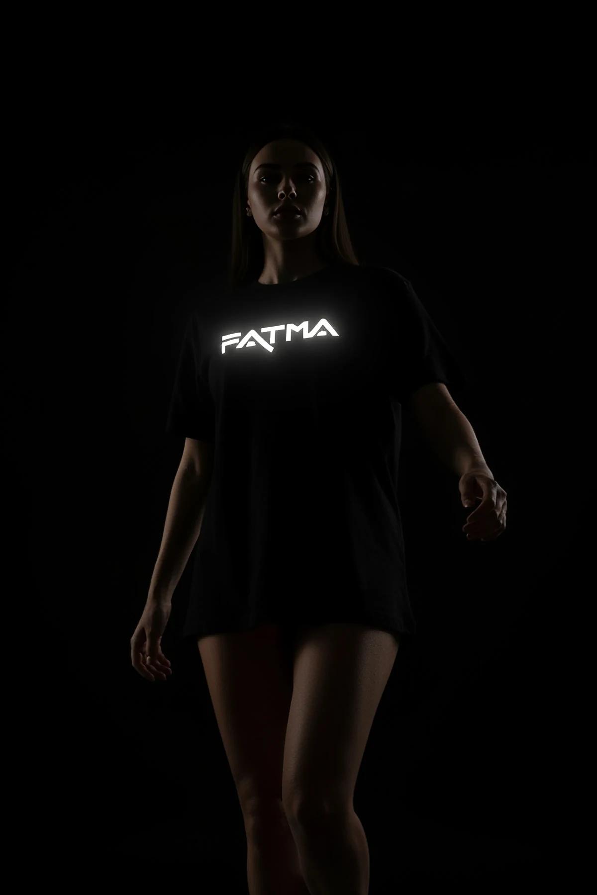 Full-length view of black oversize t-shirt worn as mini dress, mid-thigh length on 165 cm model