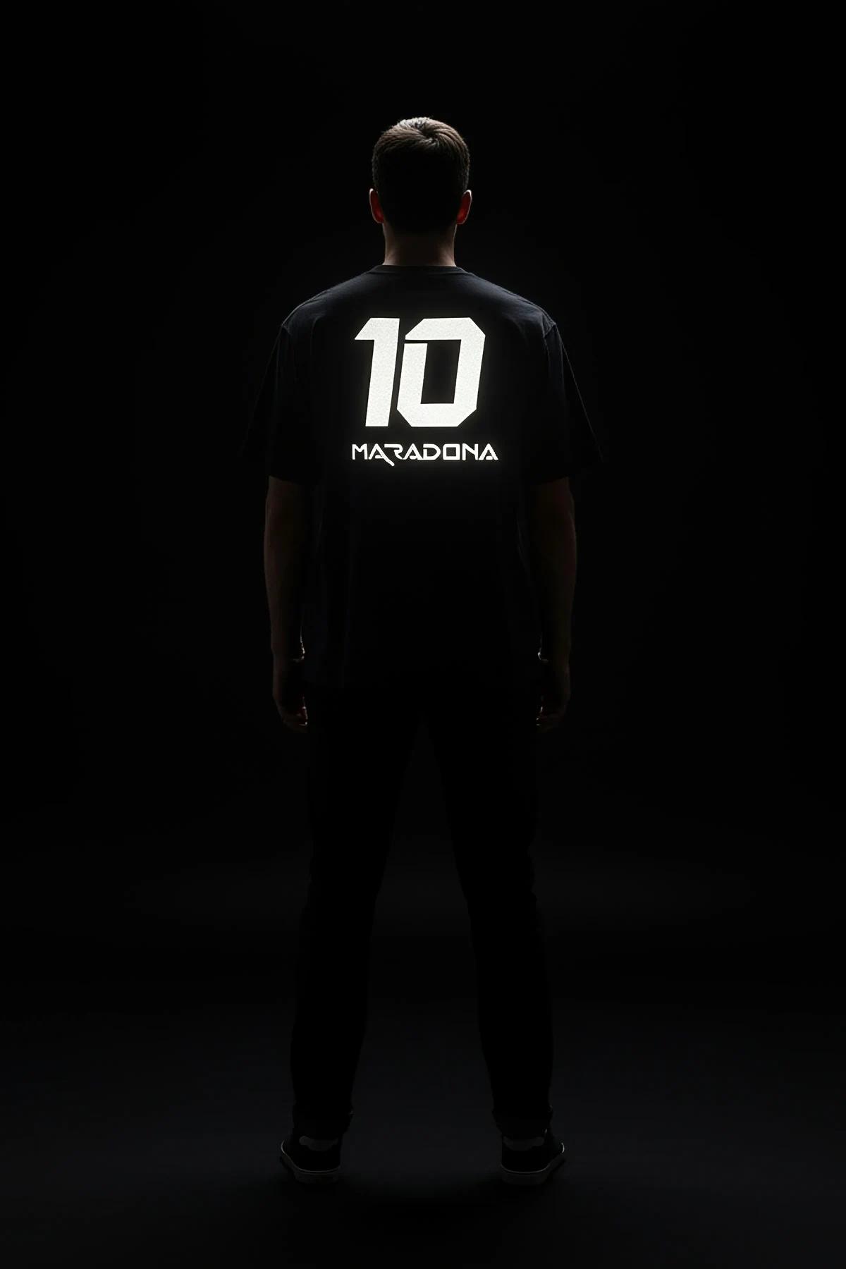 Maradona 10 oversize black t-shirt back print glowing white under camera flash against dark background
