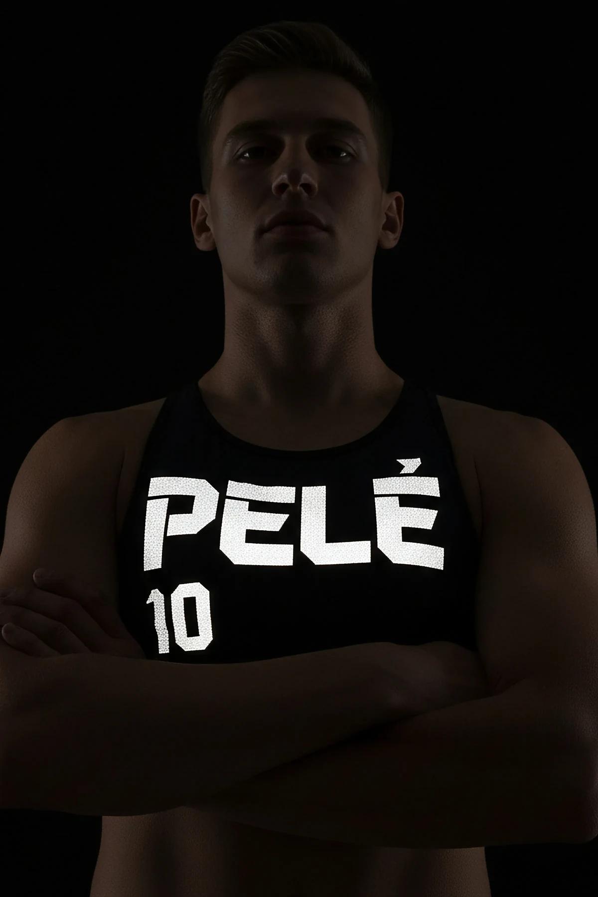 Black tank top with large retroreflective PELE 10 dot-matrix front print glowing white under direct flash