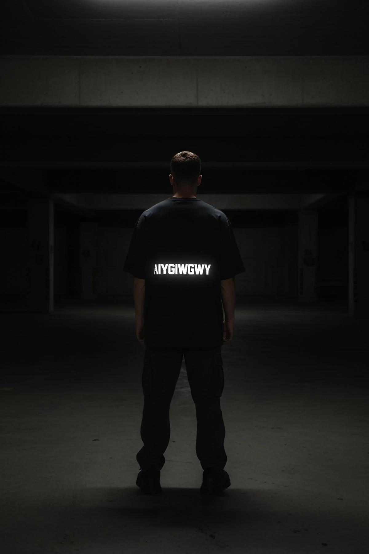 AIYDIWDWY reflective print t-shirt model in dark setting glowing slogan close-up
