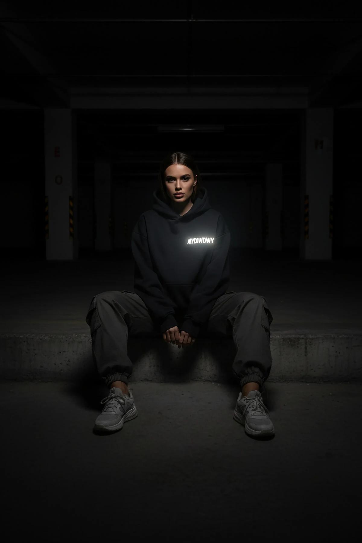 Detail of ribbed cuffs and kangaroo pocket on black cotton-blend fleece hoodie