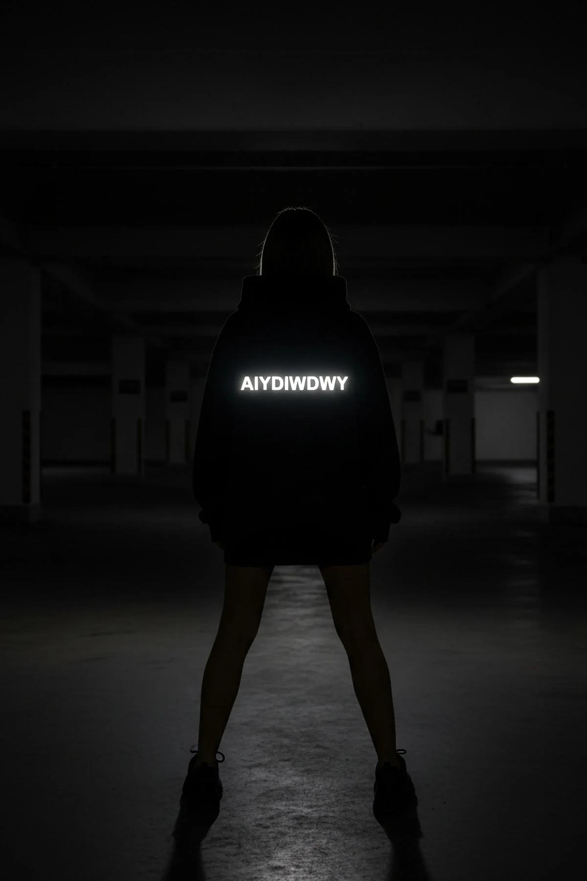 Close-up of retroreflective white arch lettering on black heavyweight fleece hoodie chest