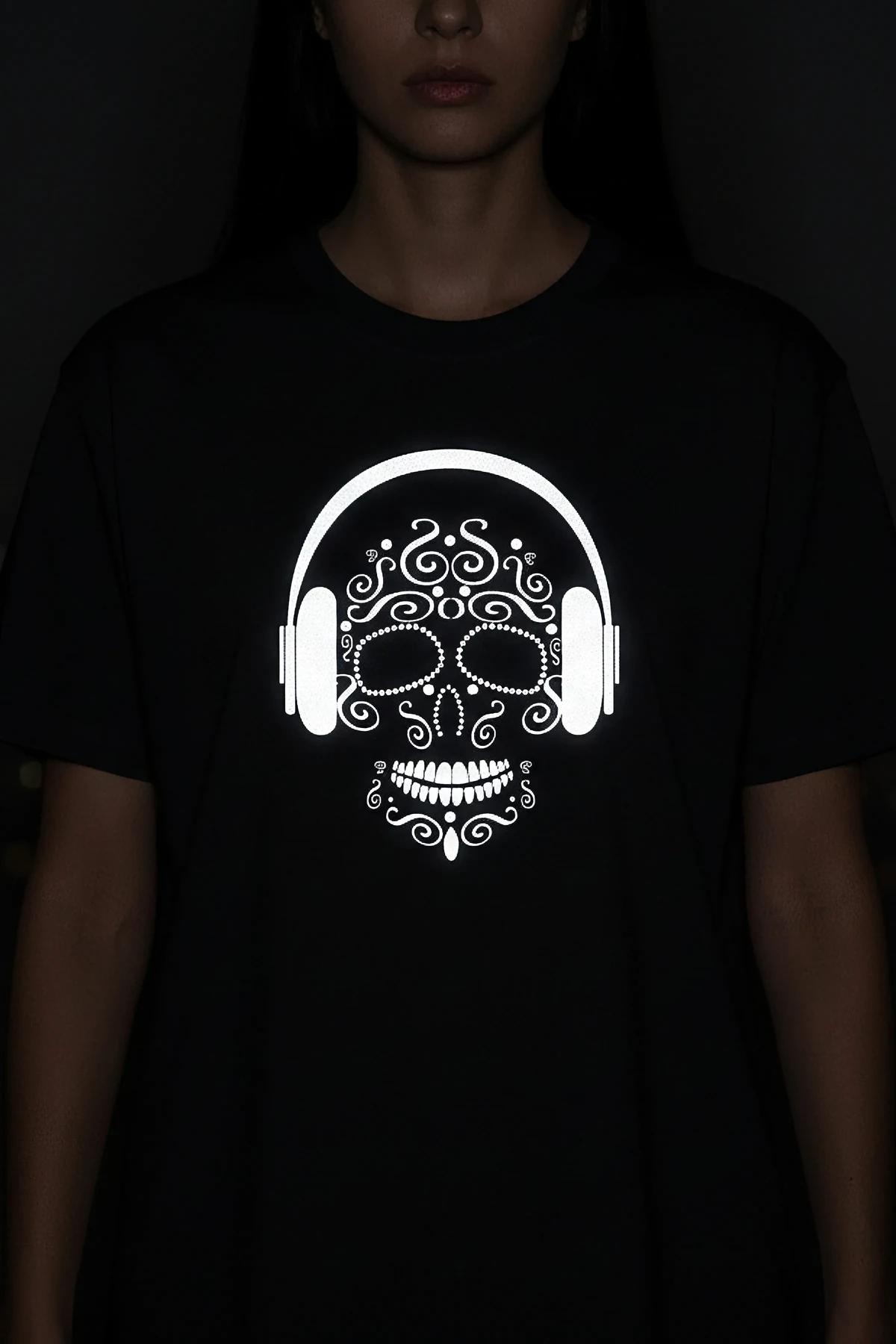 Black oversize t-shirt with white reflective sugar skull wearing headphones front print, glowing under camera flash