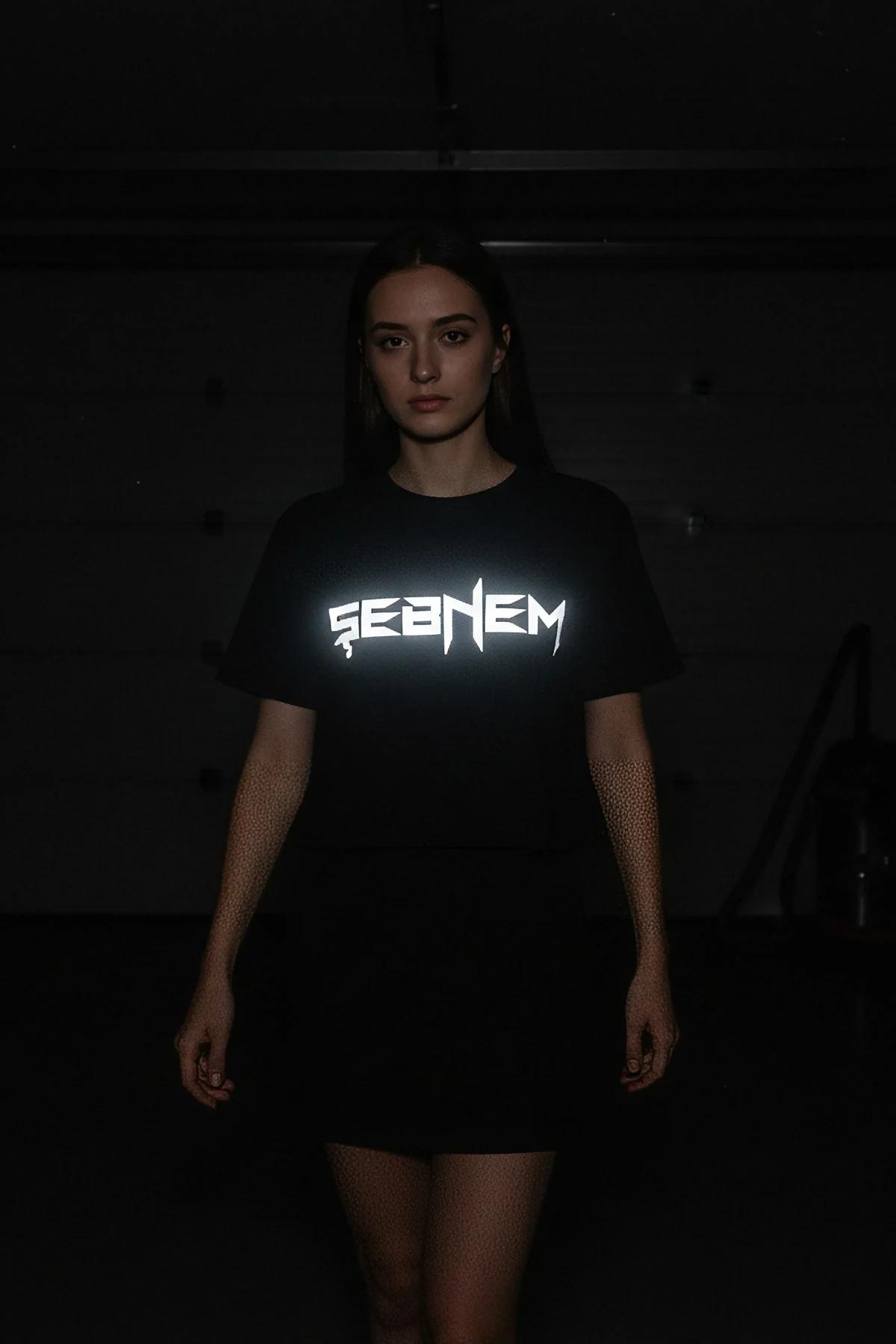reflective name print black oversized t-shirt SEBNEM bold white chest graphic glowing under flash