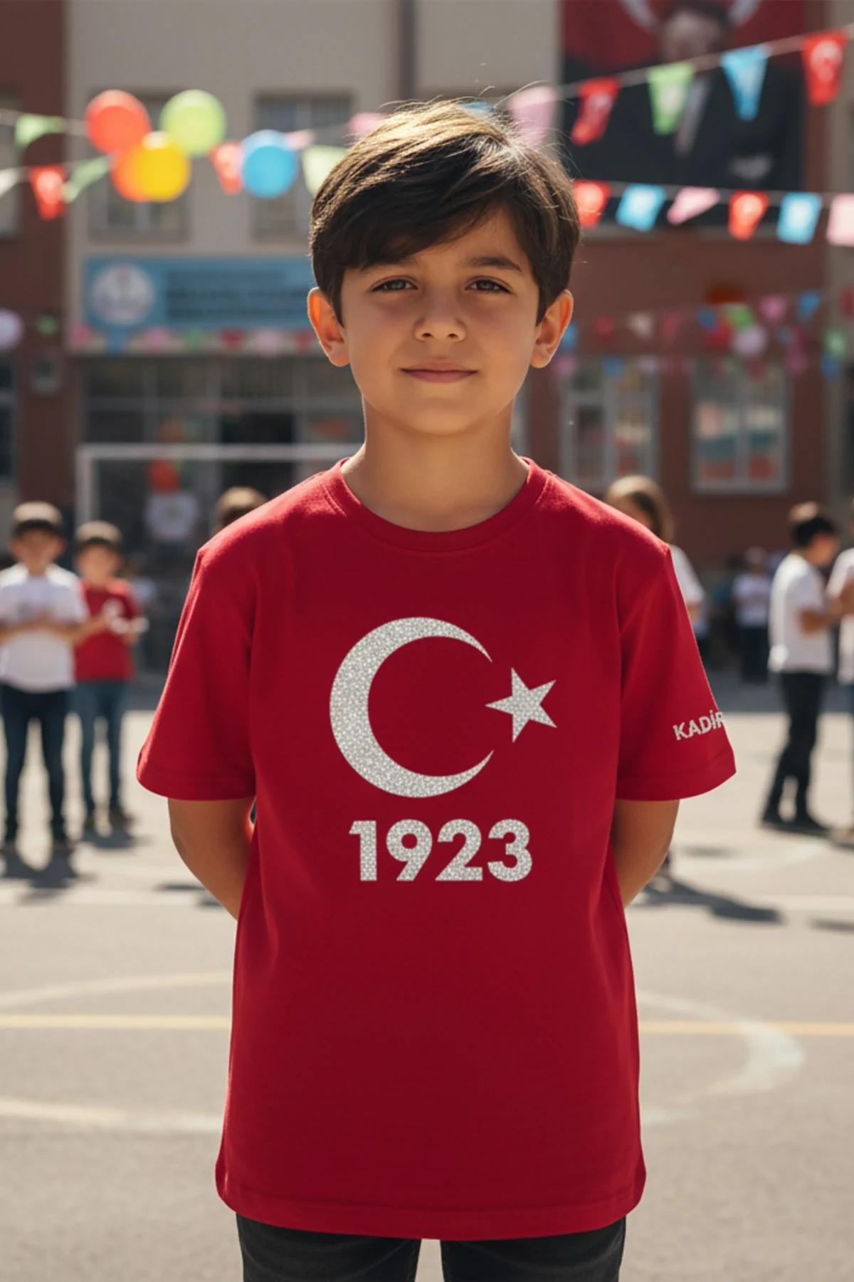 Red kids t-shirt with reflective silver crescent star and 1923 print, custom name KADIR on left sleeve, worn by a boy