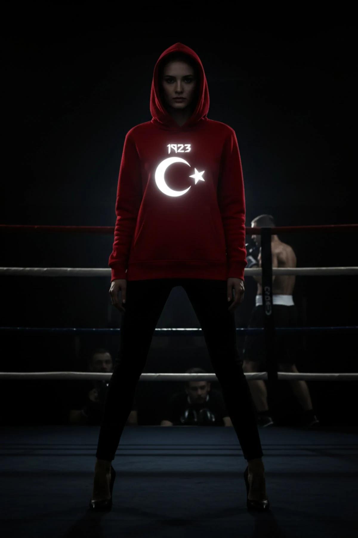 Red hooded sweatshirt with reflective crescent star 1923 front print glowing white in dark setting