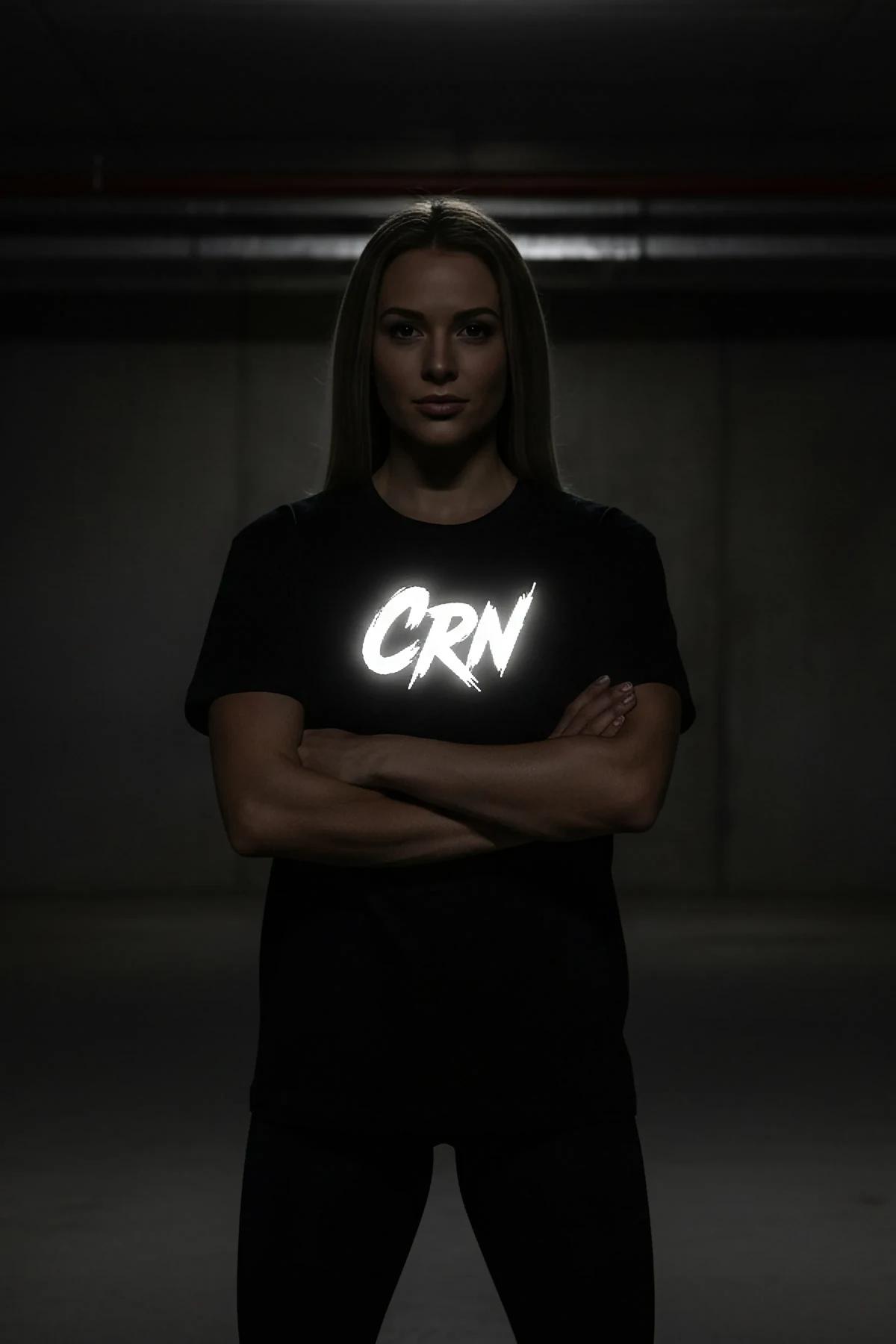 close-up of retroreflective CRN graffiti lettering on black cotton t-shirt chest