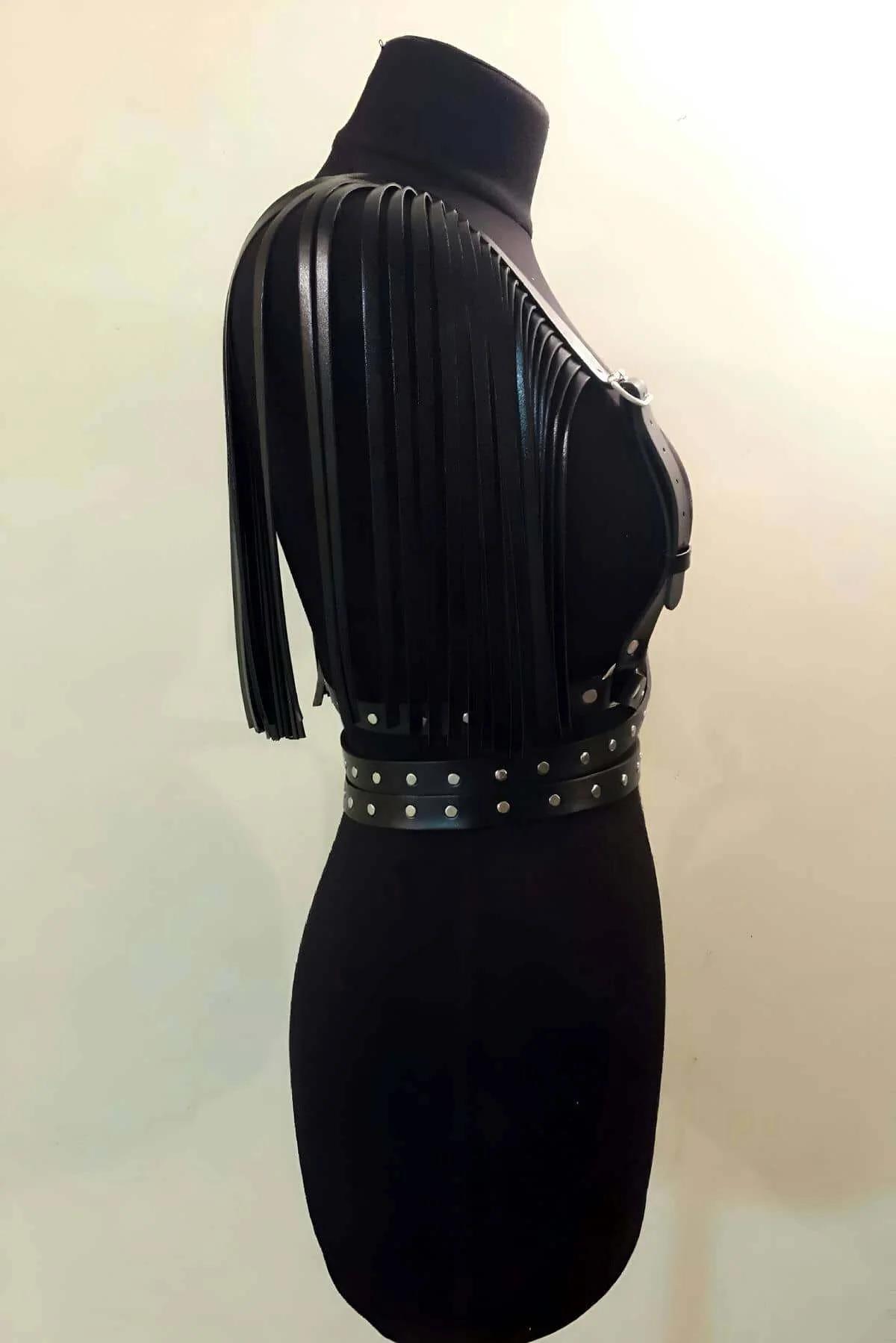 long black faux leather fringe strips cascading from shoulder straps of chest harness