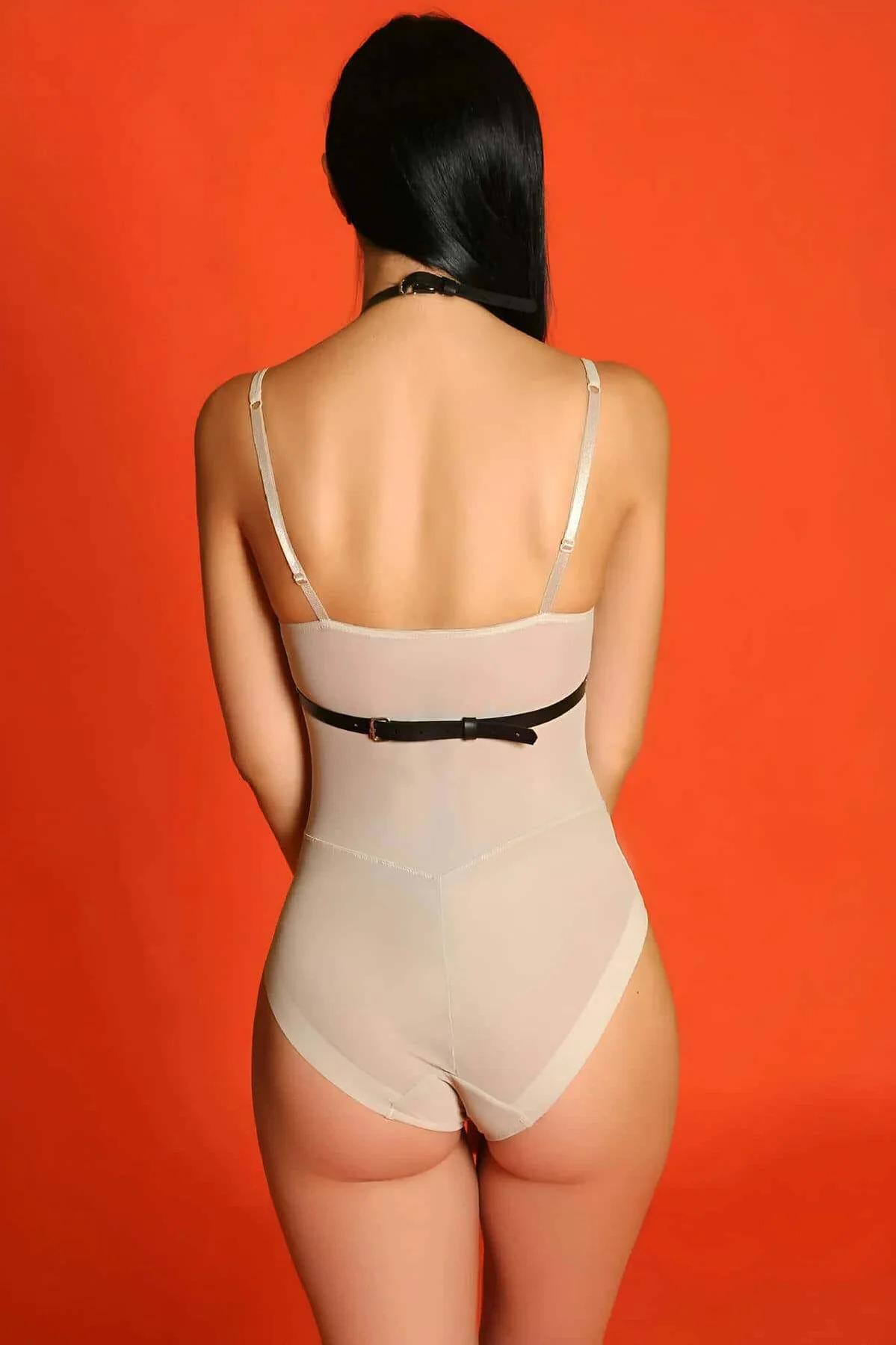 Matte black vegan leather chest harness with gold-toned buckles and collar neck strap detail