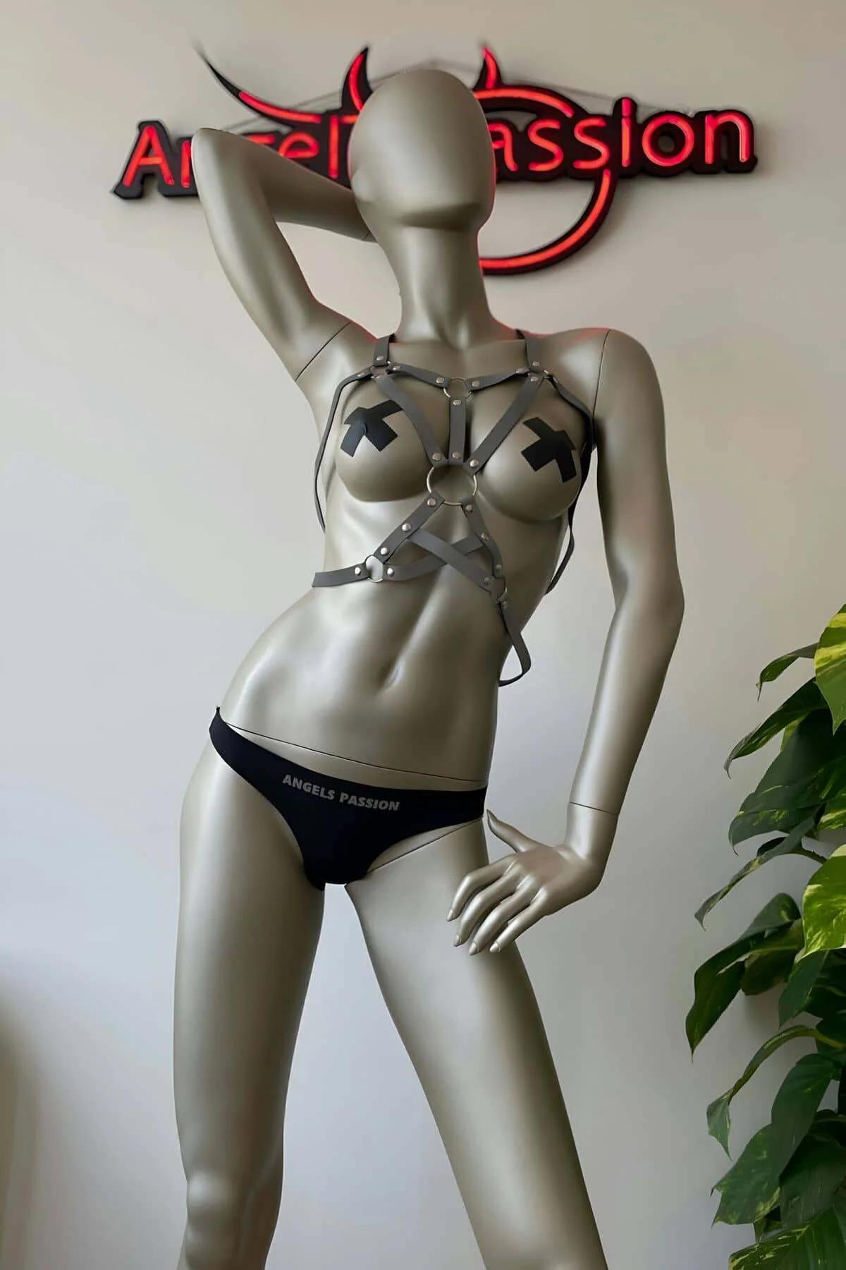 Full body view of white reflective body harness with upper chest cage and lower waist cross design