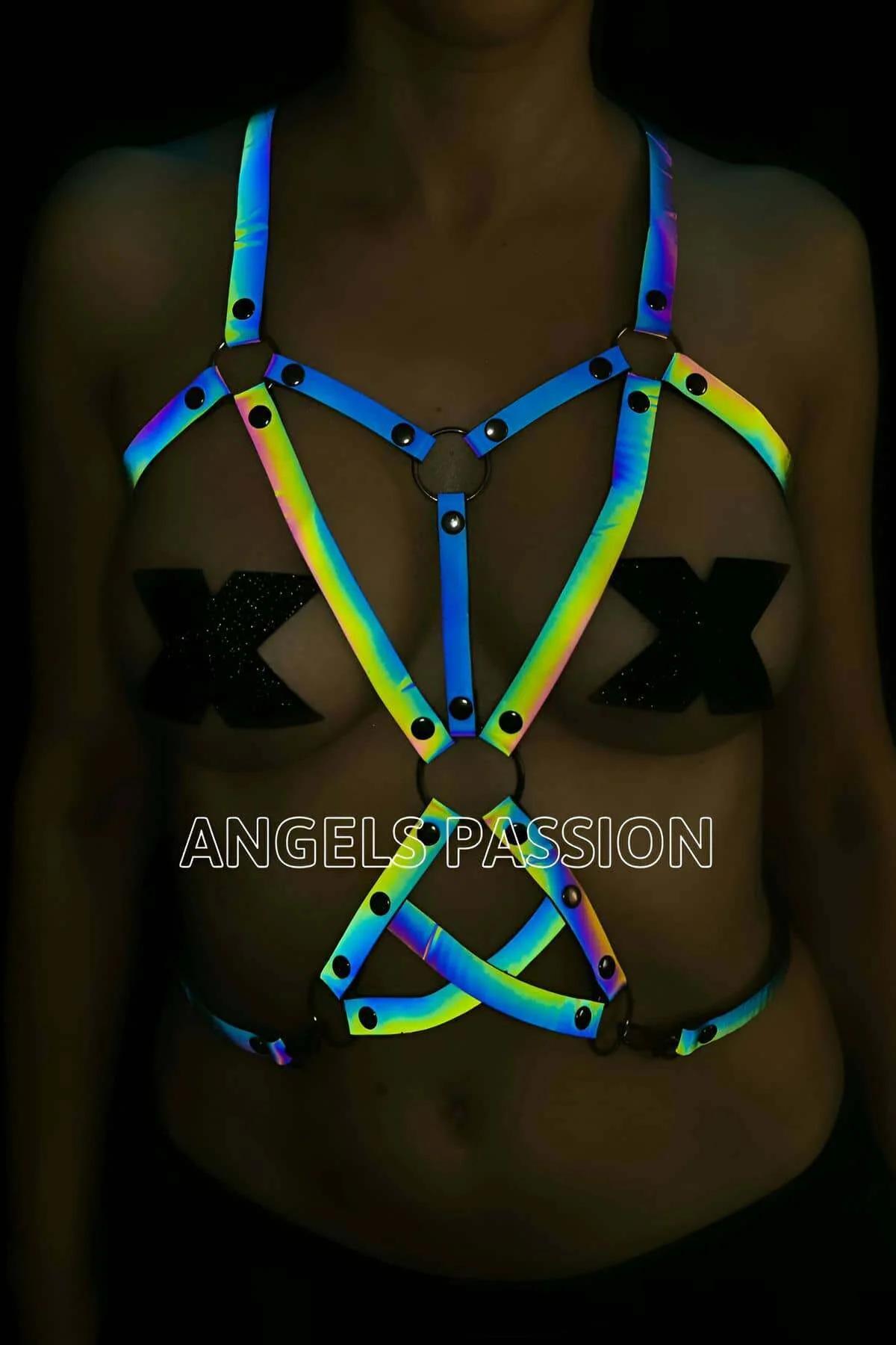 Reflective rainbow body harness with iridescent blue green yellow straps and black O-ring hardware geometric cage design
