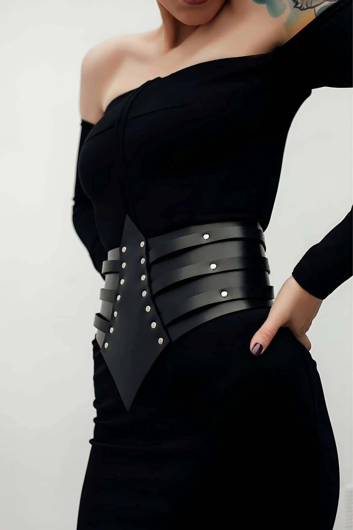 side view of black wide cinch belt with adjustable silver buckle closure at hip