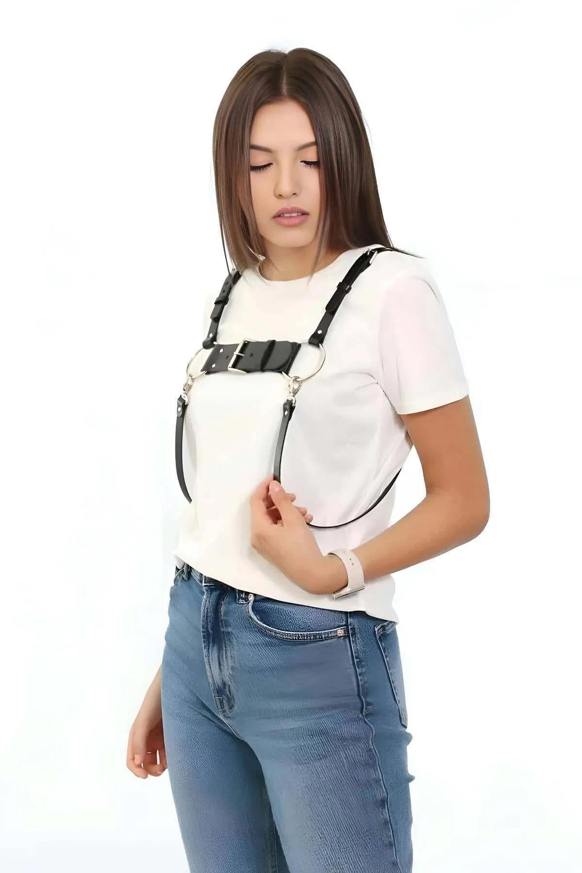 close-up of black PU chest harness showing silver O-rings and rectangular buckle panel detail