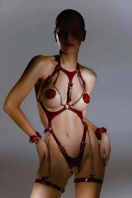 Red faux leather full body harness with detachable gold chains and matching wrist cuffs, multiple adjustable buckle straps