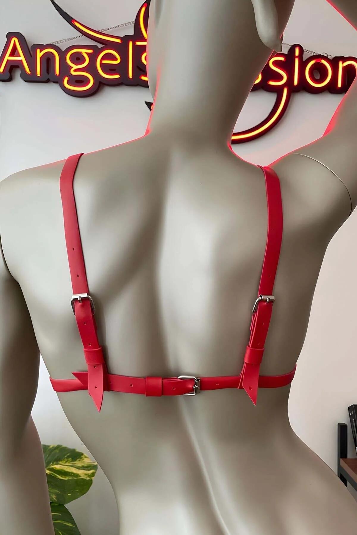 Red faux leather harness bra layered over black shorts, full torso styling view