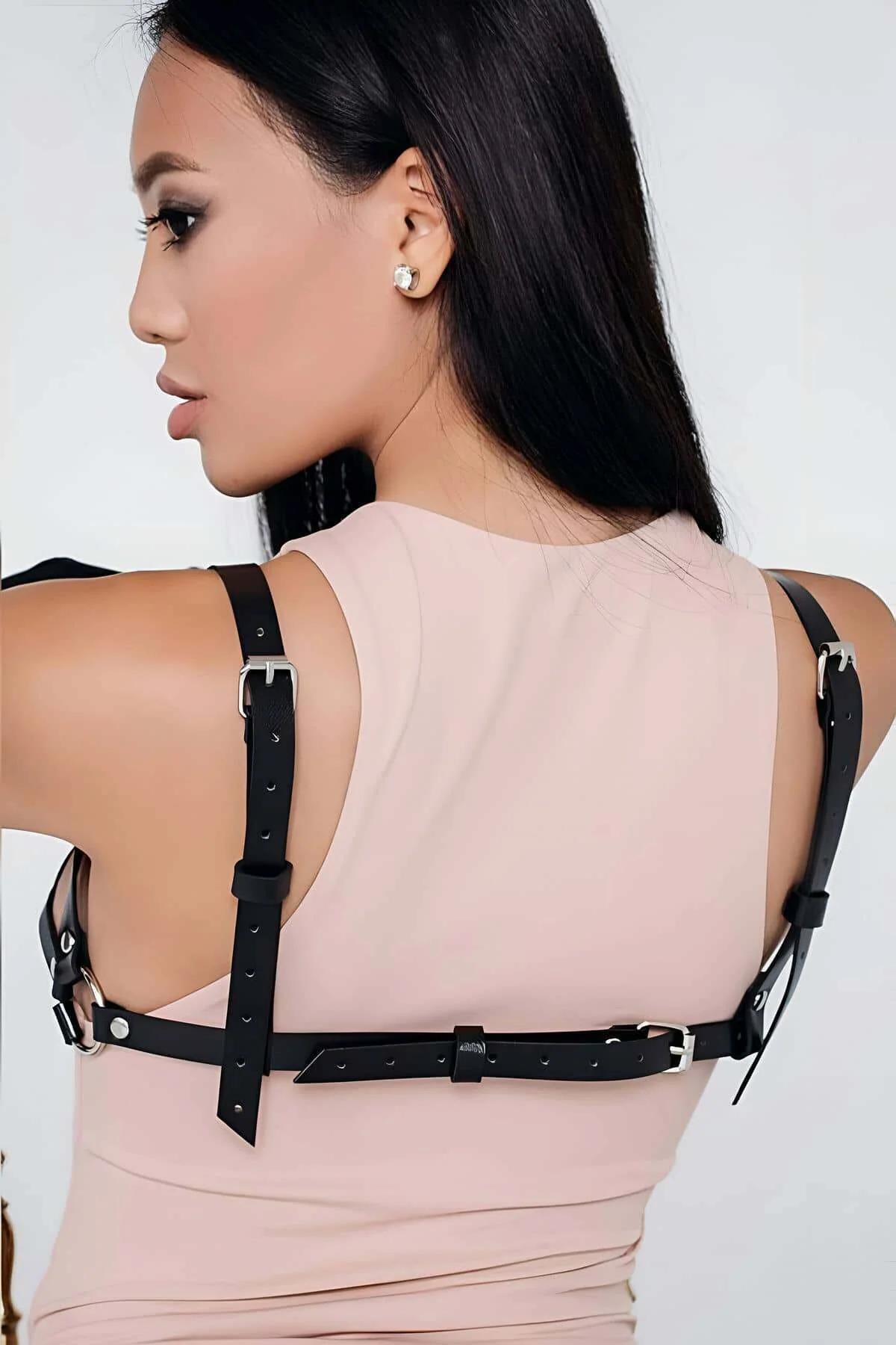 adjustable black faux leather cage harness bra silver O-ring connectors close-up detail
