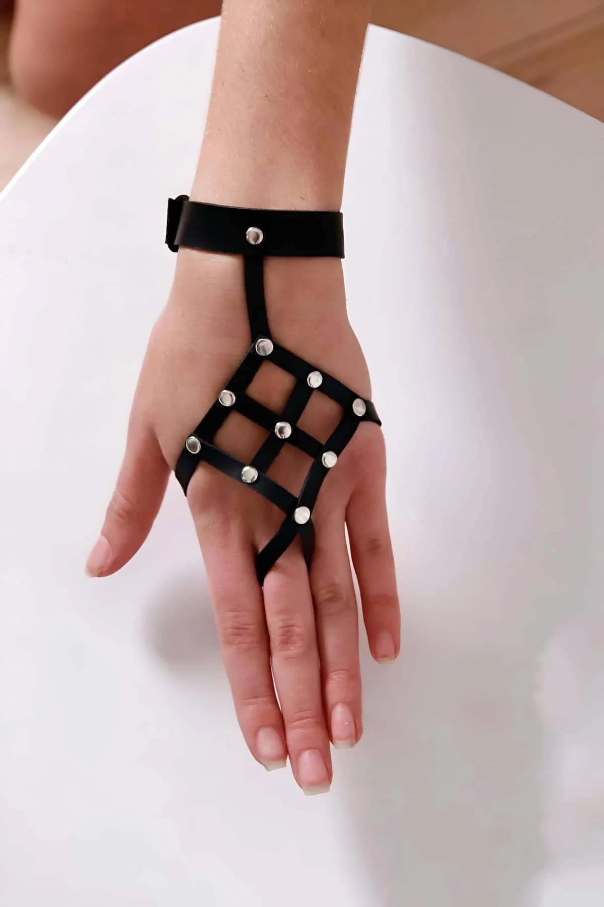 Black grid hand harness flat lay showing full cage structure and 3 cm wrist cuff band