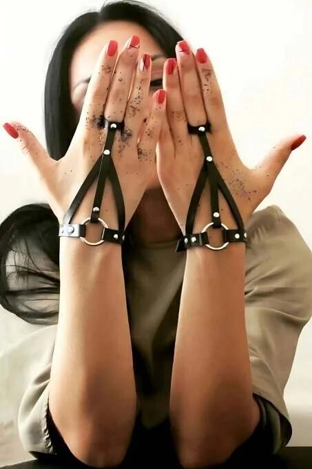 black PU leather hand harness showing triangular strap panel across back of hand with silver snap hardware