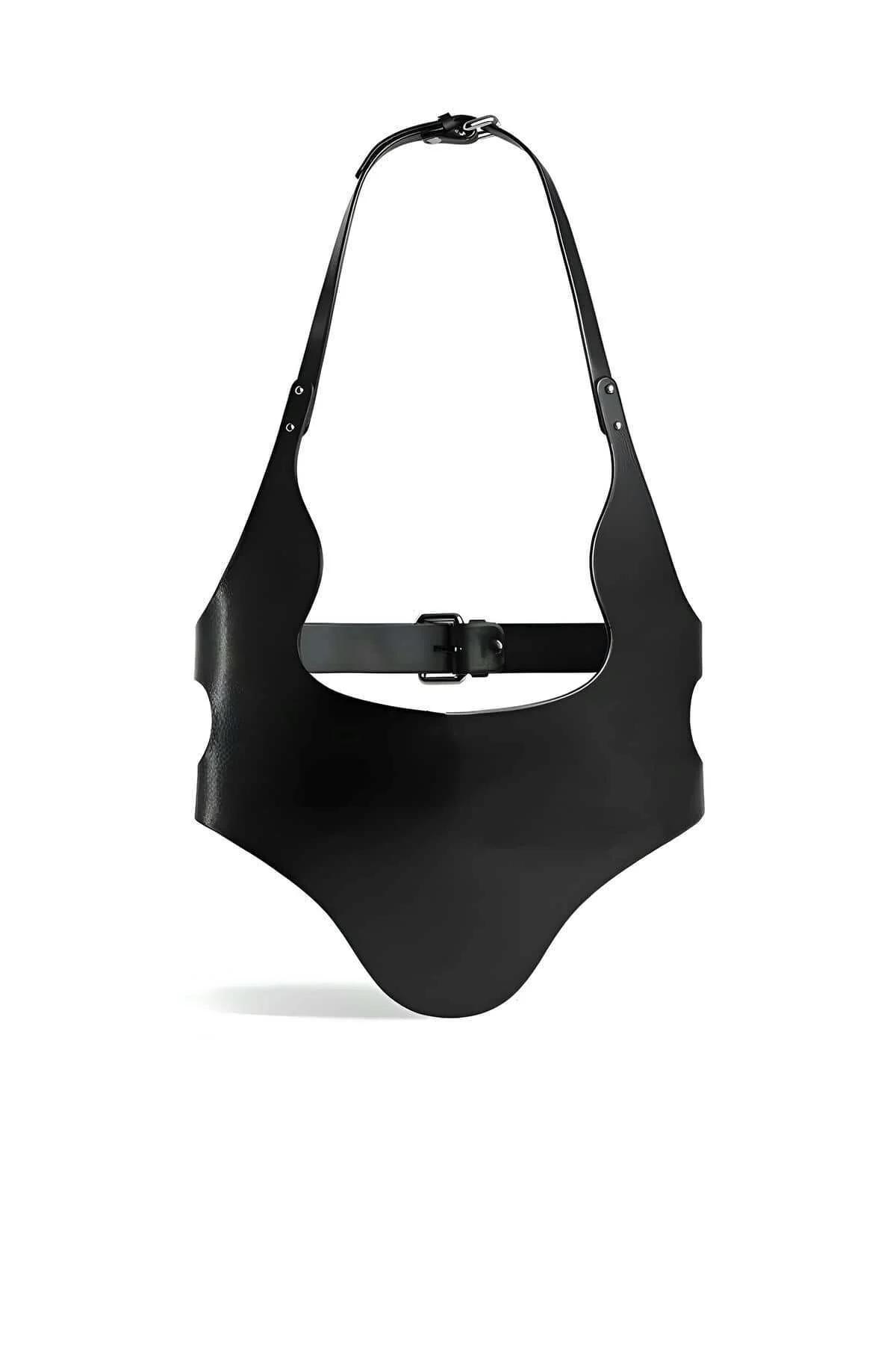 Close-up of black PU leather waist panel and polished silver O-ring hardware on harness belt
