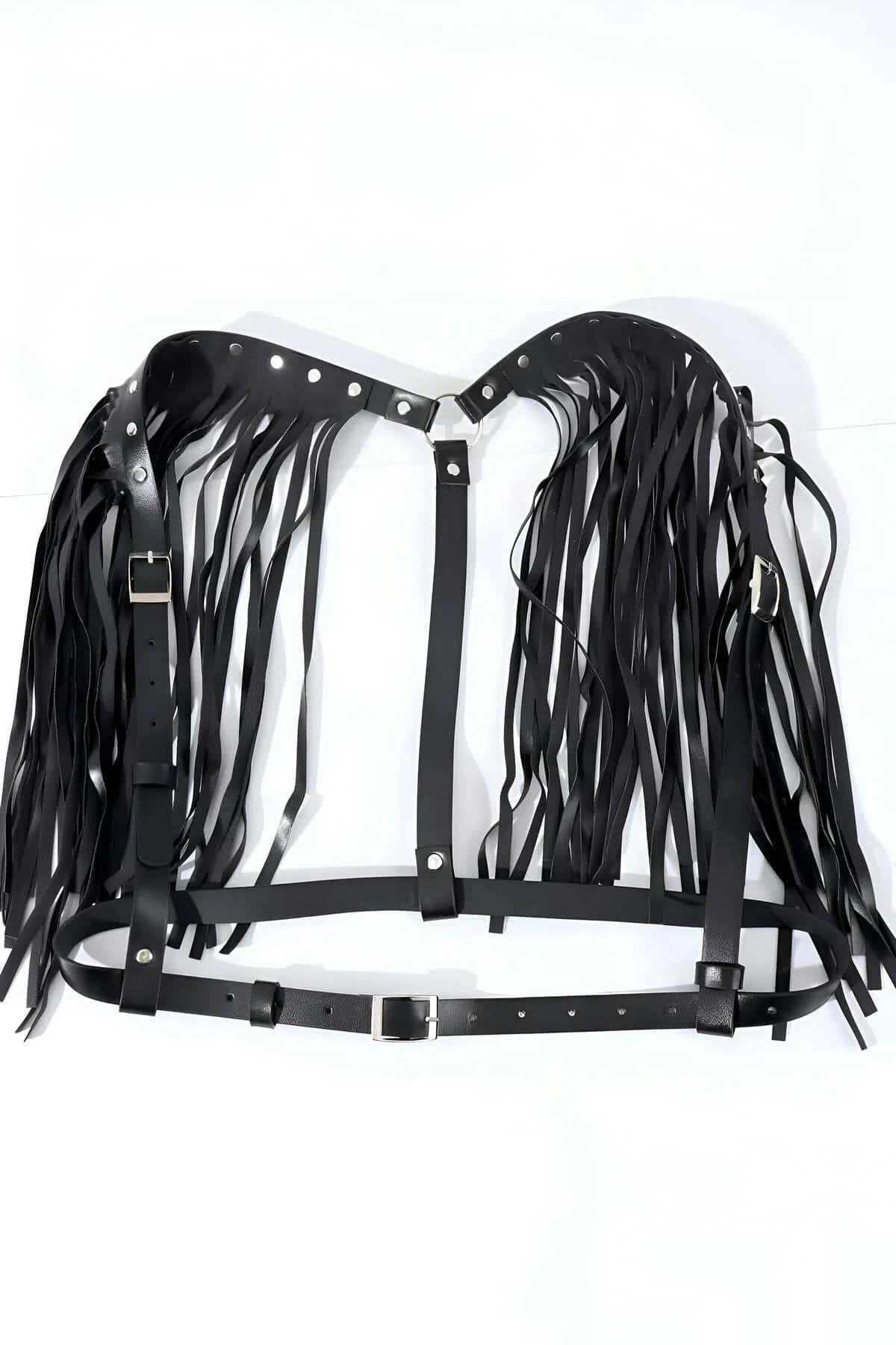 Close-up of black faux leather shoulder pad with silver rivet accents and hanging fringe strips