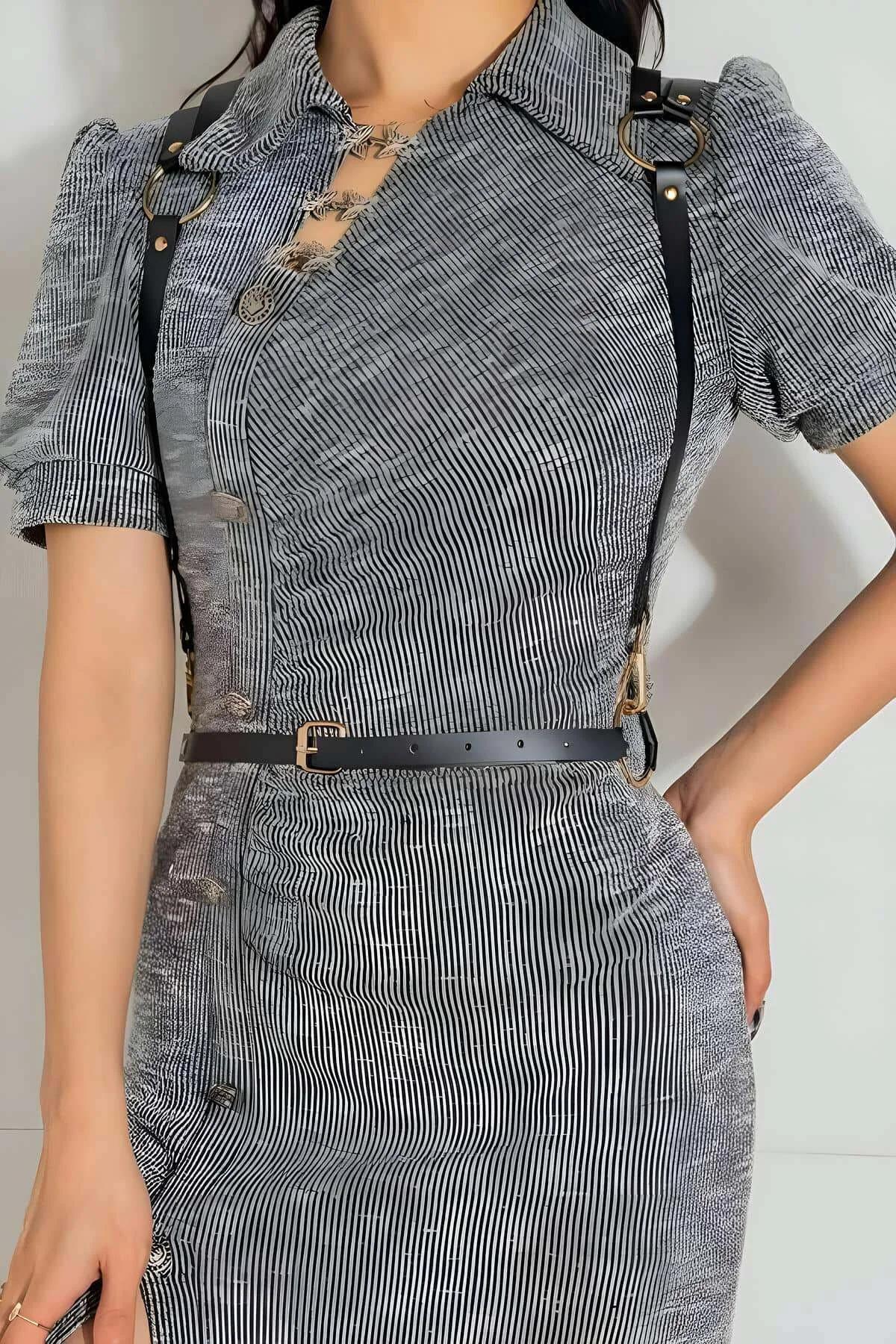 Close-up of gold-tone O-ring and converging black faux leather shoulder straps on back harness