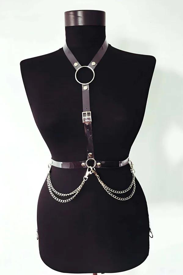 Black patent faux leather chest harness with silver O-rings and three draped waist chains on mannequin
