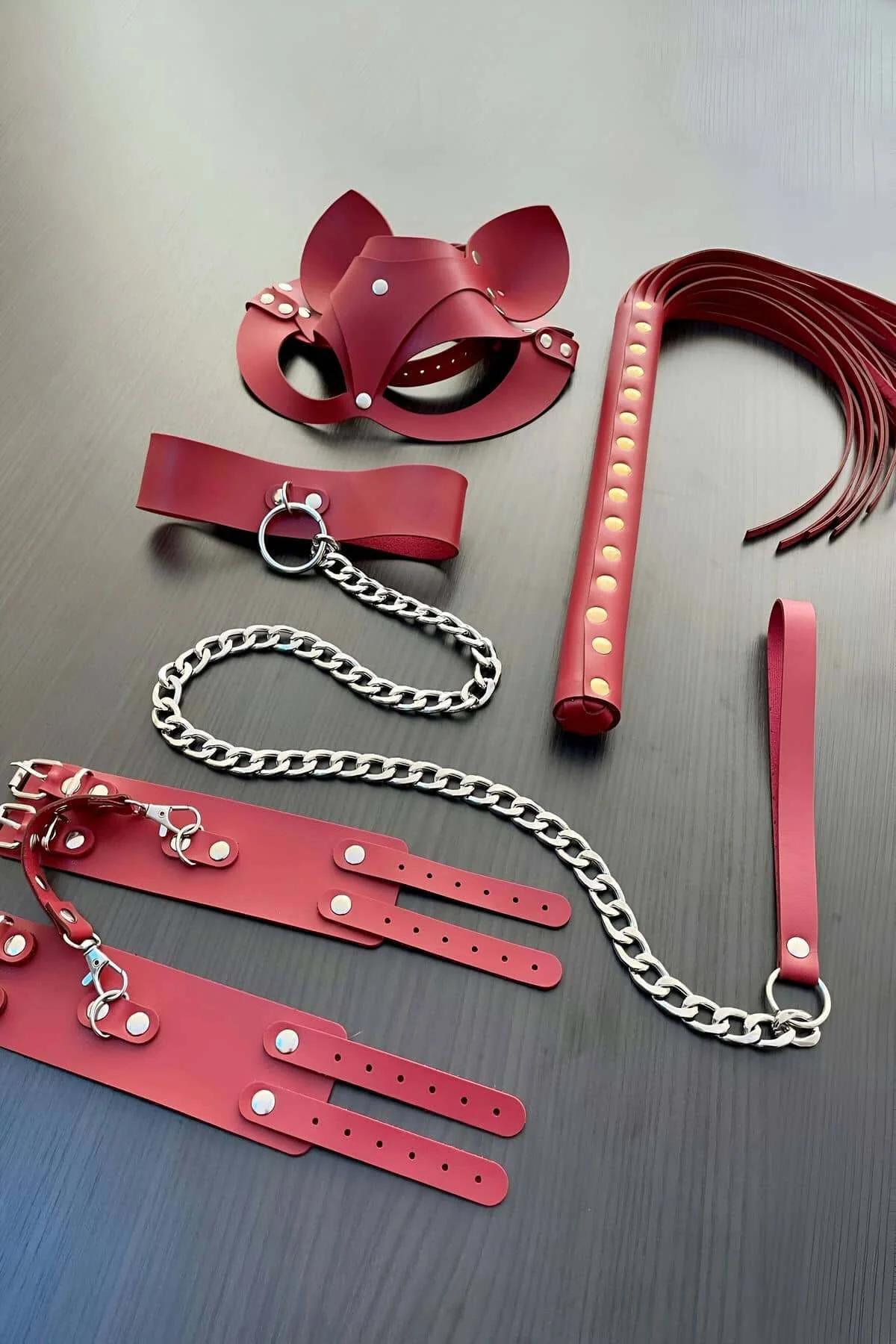 Red faux leather collar with silver O-ring and attached silver curb chain leash detail