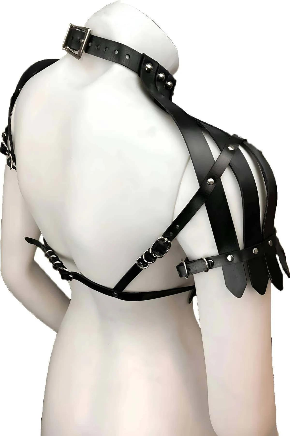 close-up of silver stud detail along neckband of black faux leather shoulder harness