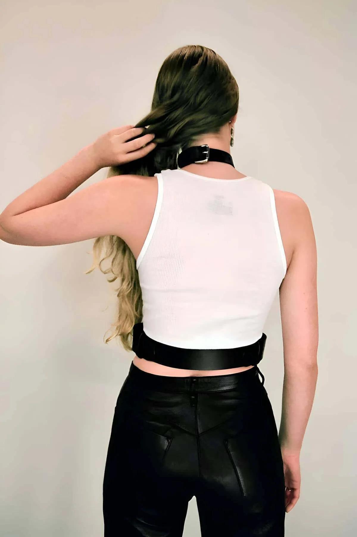 Wide black faux leather waist band with silver side loop hardware, adjustable fit detail