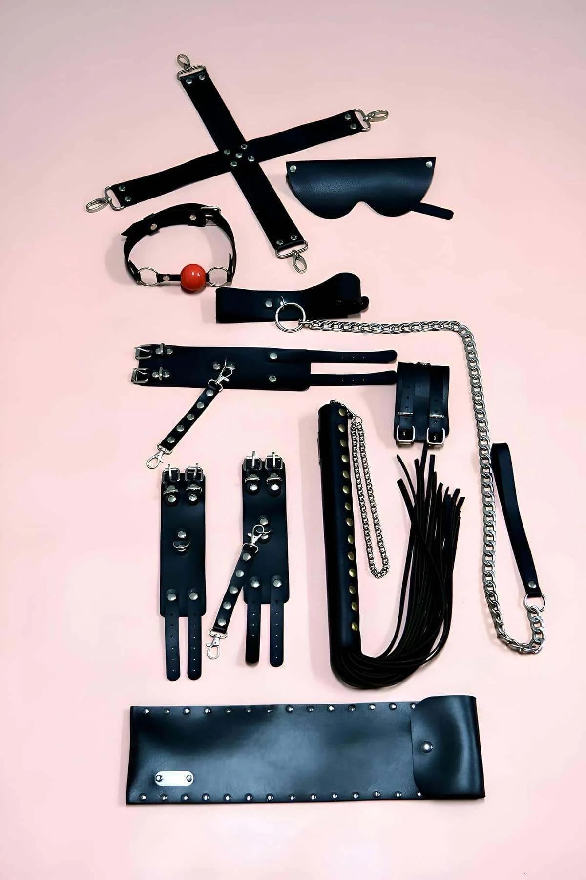 Black vegan leather wrist and ankle cuffs with silver stud detail and lobster clip attachments