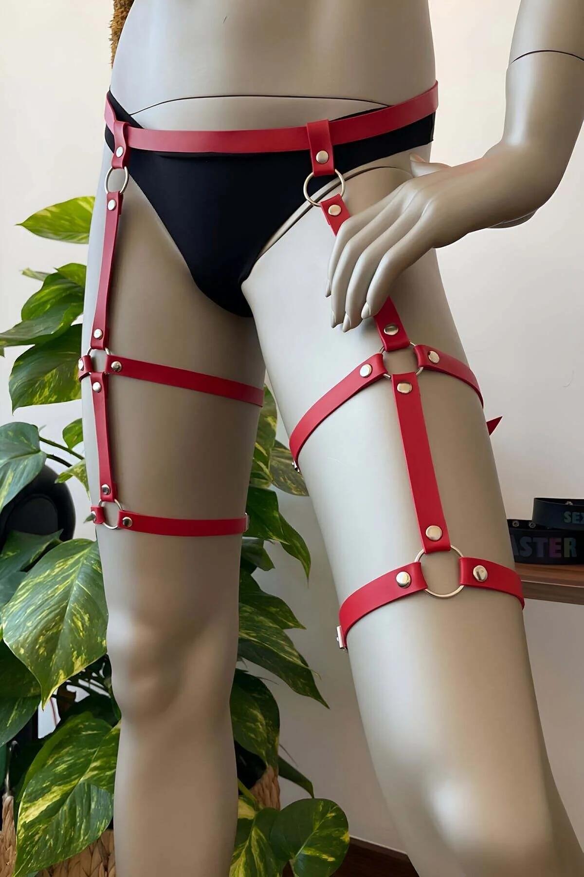 Close-up of red PU leather thigh straps with silver rivet and O-ring hardware detail