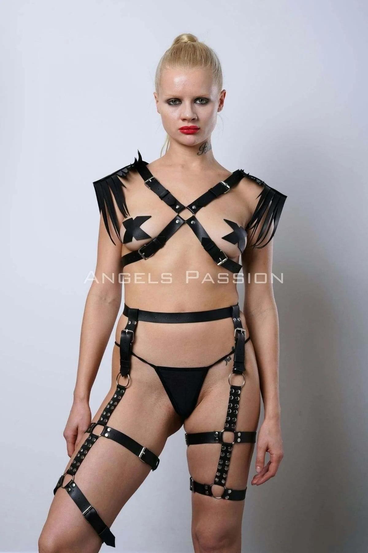 Close-up of black faux leather fringe shoulder panels with silver buckle detail on chest harness
