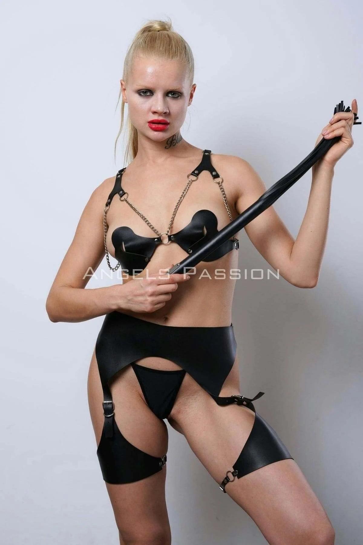 Gold-tone zinc alloy O-rings and buckle hardware on black faux leather leg strap bands, close-up