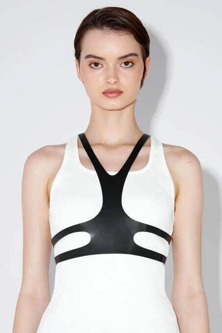Close-up of black PU faux leather Y-panel straps converging at sternum V-point