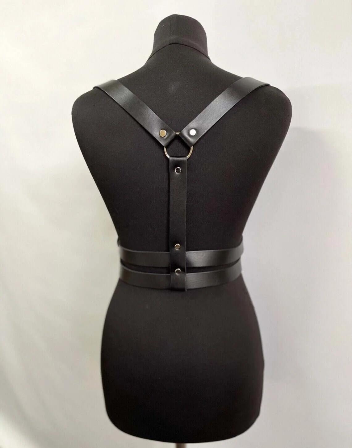 Front view of black PU faux leather body harness showing two stacked adjustable waist straps with silver buckles