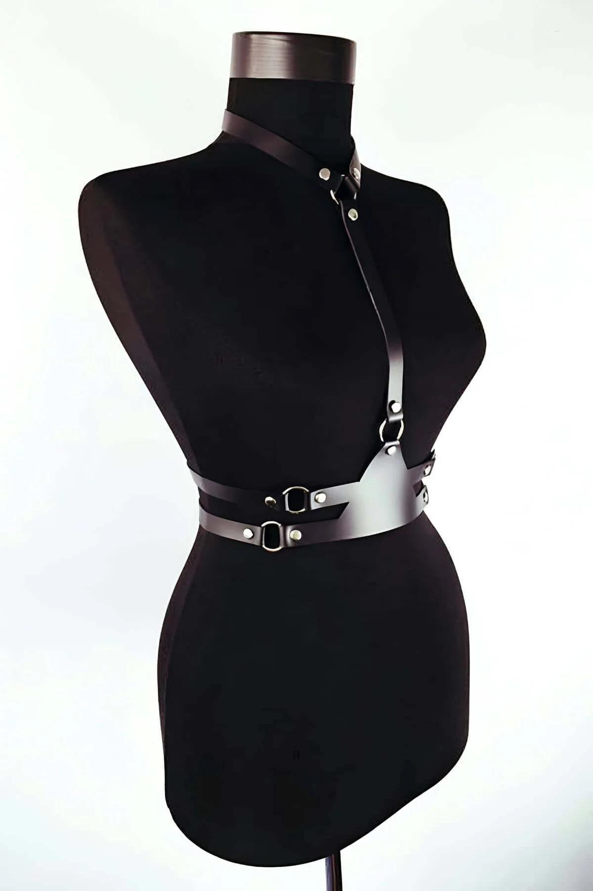 Double waist belt section of black faux leather harness showing parallel straps and D-ring hardware