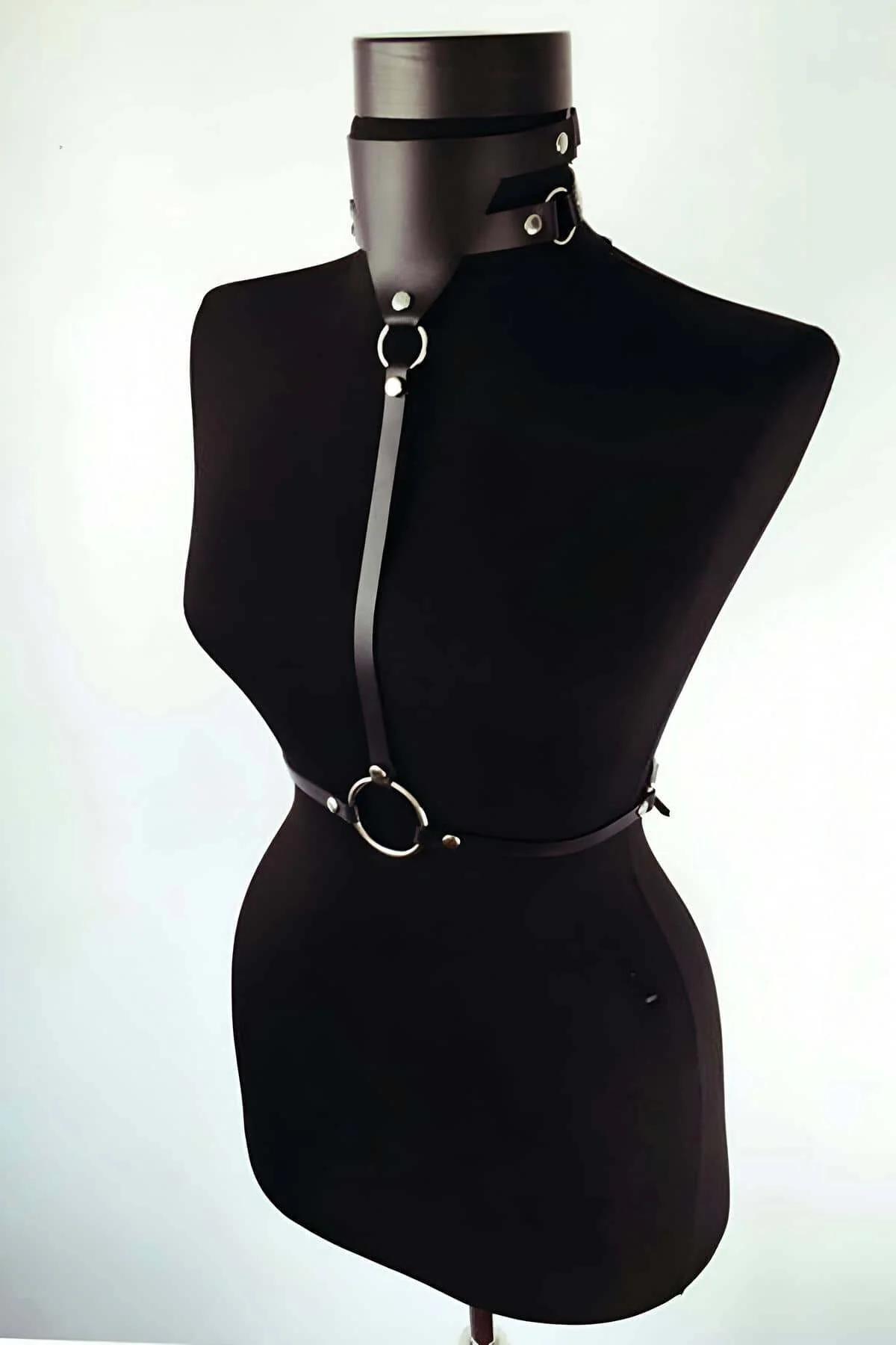 Black PU leather harness vertical center strap and silver waist O-ring detail close-up