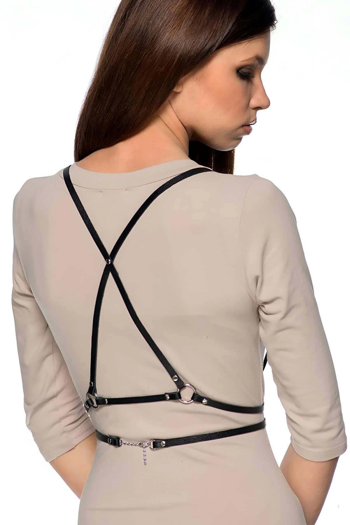 Adjustable black faux leather chest harness showing silver slider buckles on shoulder straps