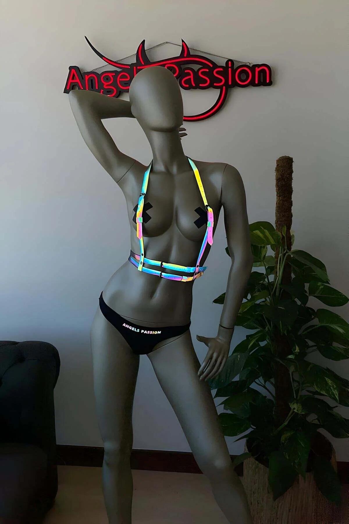 Multi-color reflective harness worn over black shorts showing full shoulder-to-waist cage silhouette