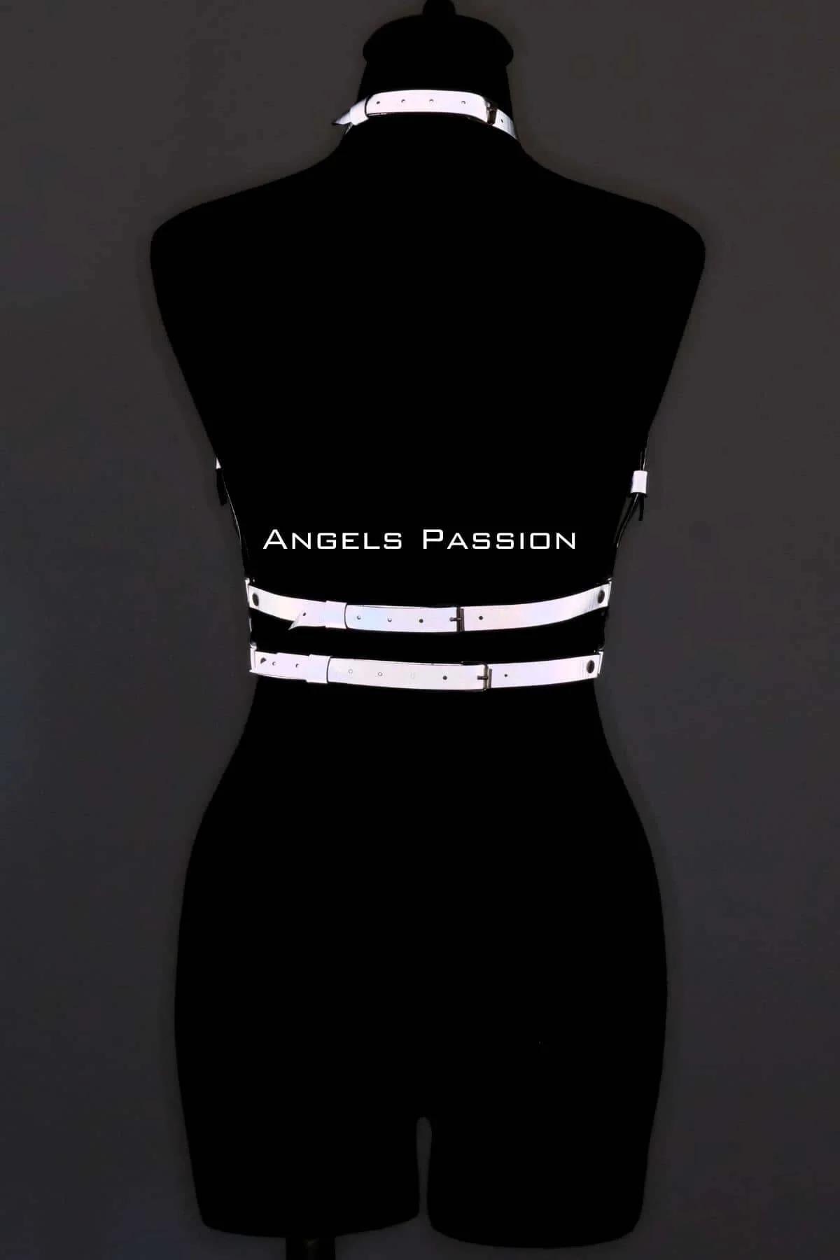 Reflective chest harness worn over black top showing structured torso cage silhouette
