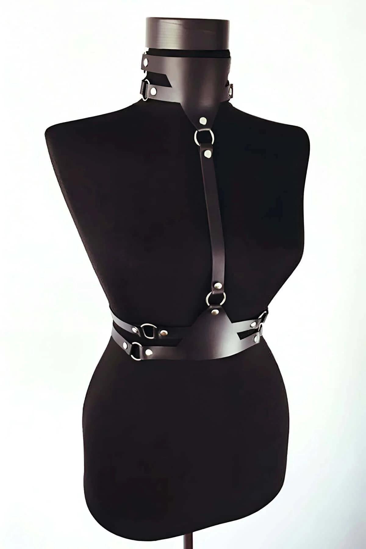 close-up of silver O-ring and dome rivet detail on black faux leather harness strap