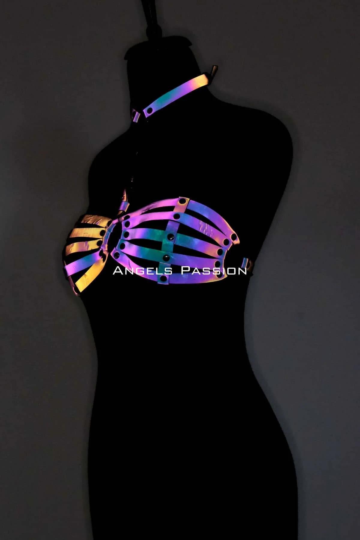 Close-up of iridescent harness O-ring center and adjustable back closure on reflective faux leather straps