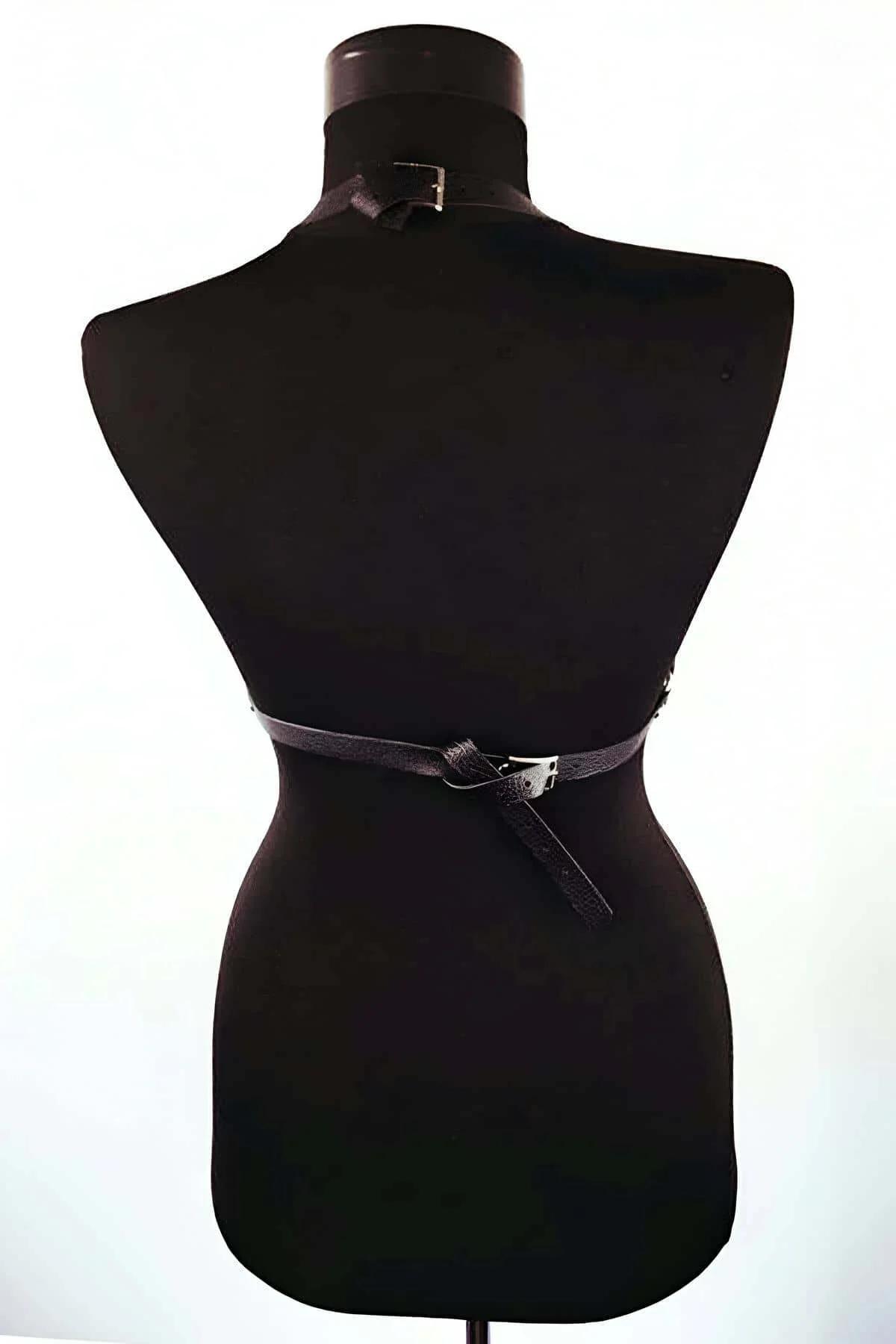 close-up of silver O-ring and rivet closures on black PU leather chest harness straps