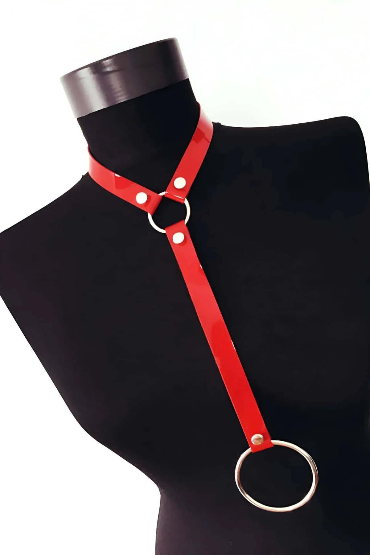 Close-up of silver snap-stud closures on red patent PU choker harness band