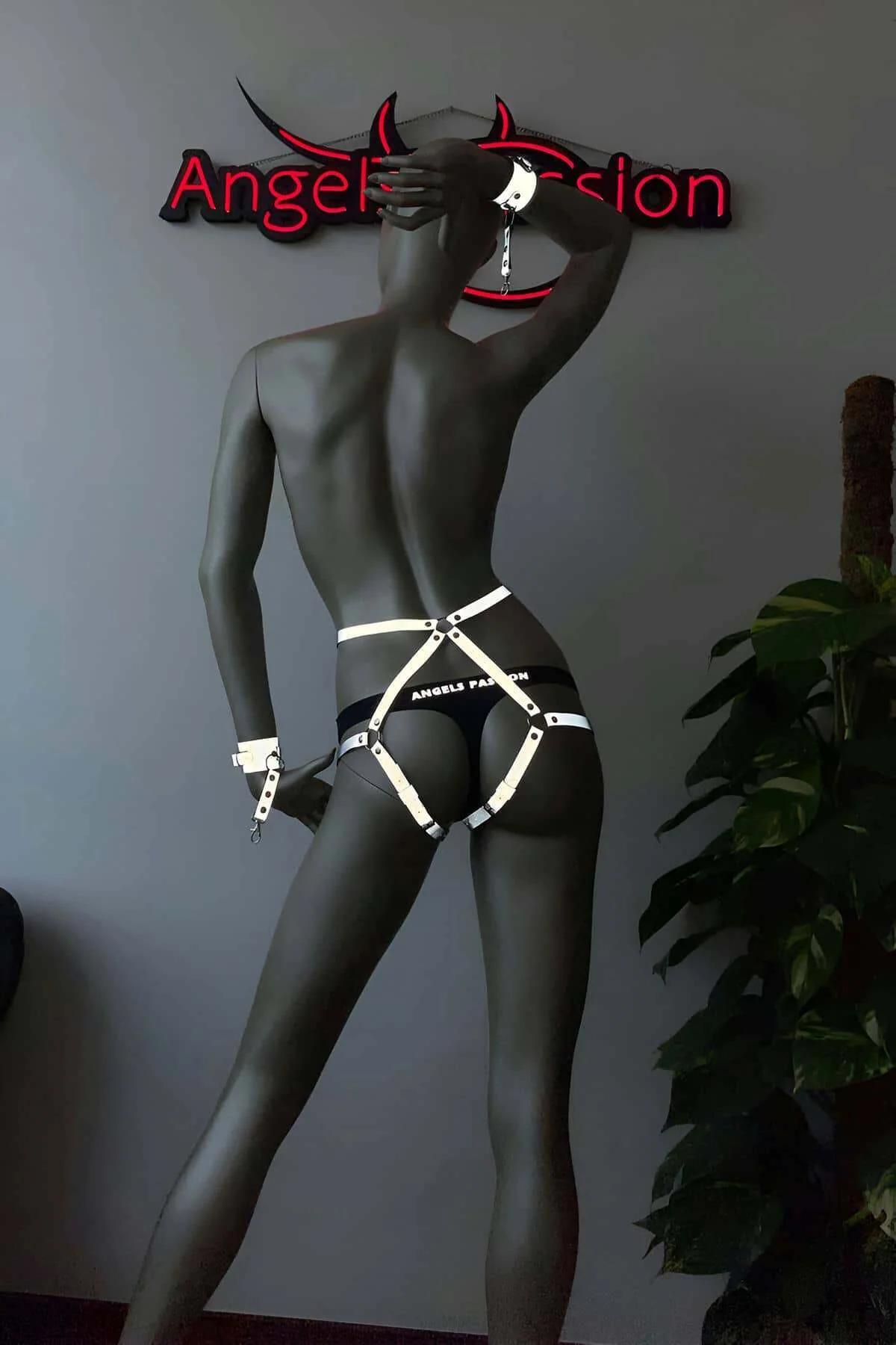 White reflective body harness worn under UV light highlighting glowing strap geometry