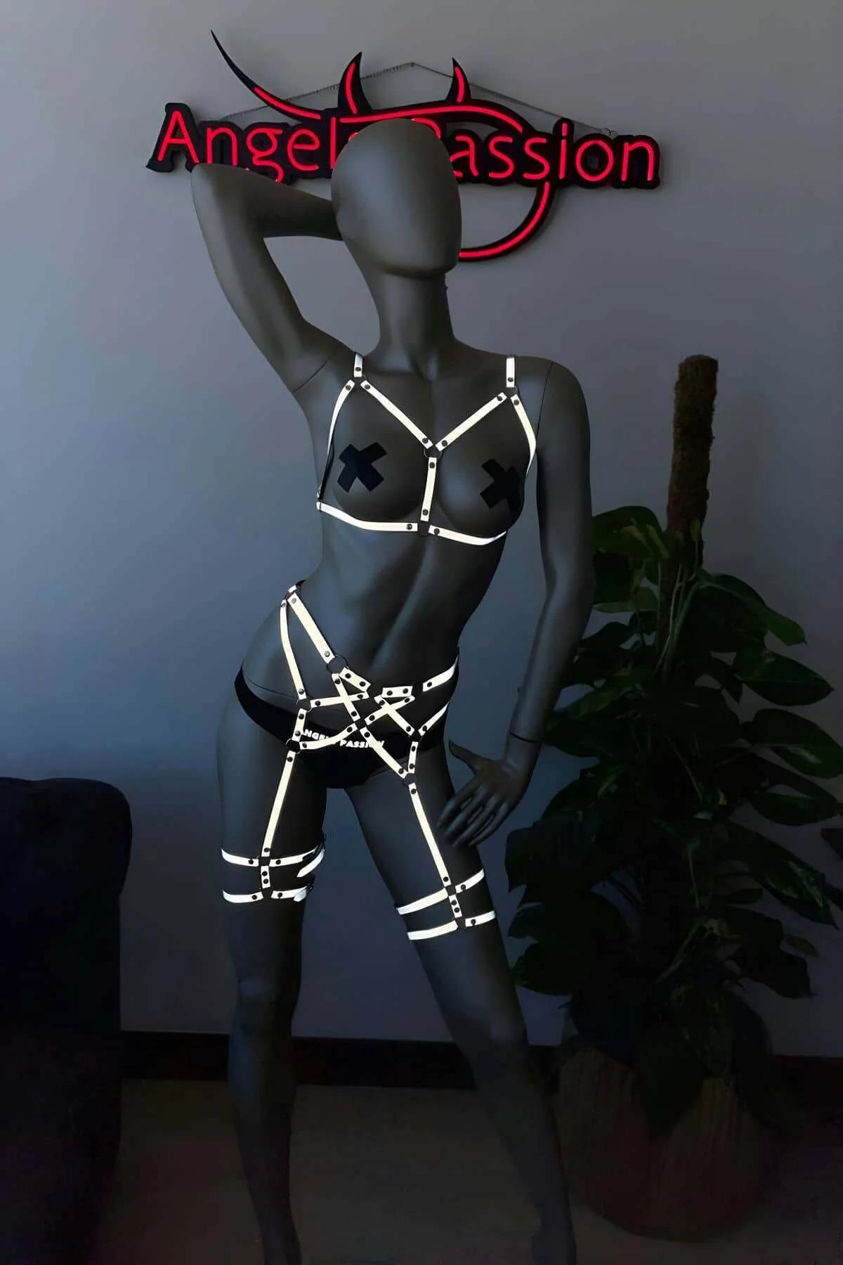 Double thigh garter bands of white reflective harness, upper mid-thigh and lower above-knee placement