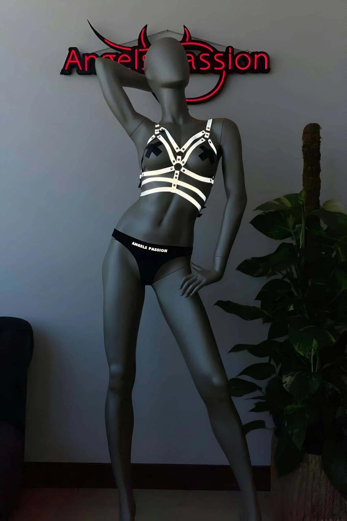 Silver slide buckle and strap adjustment detail on reflective festival harness set