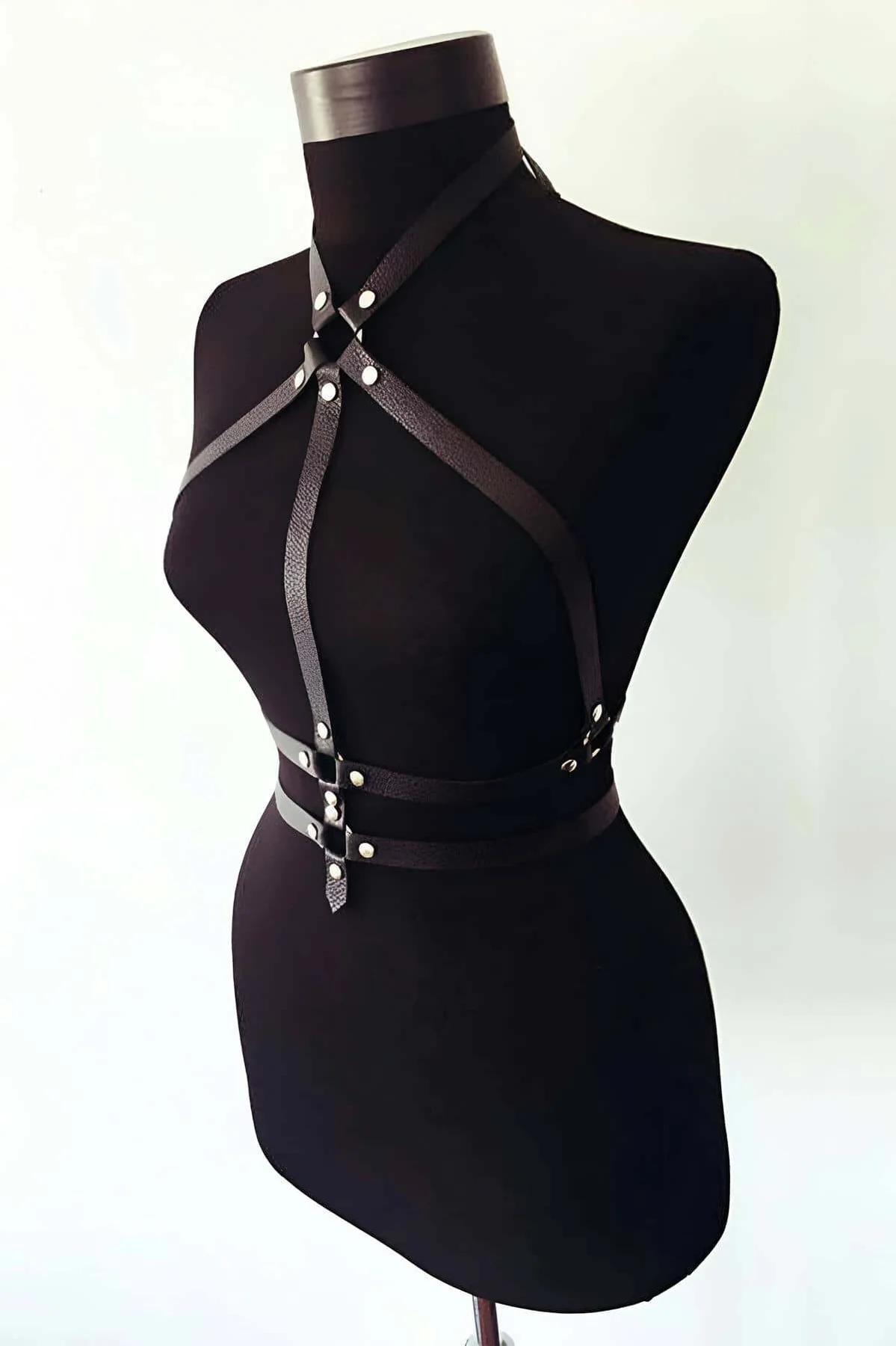close-up of silver O-ring center detail on black PU leather chest harness with dome rivets