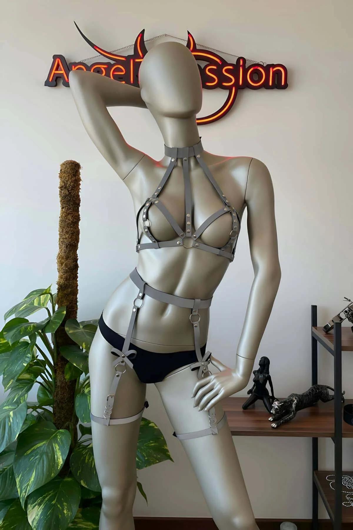 Close-up of silver-tone slider buckle and reflective woven strap detail on white festival harness set